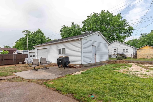 detached garage featuring fence