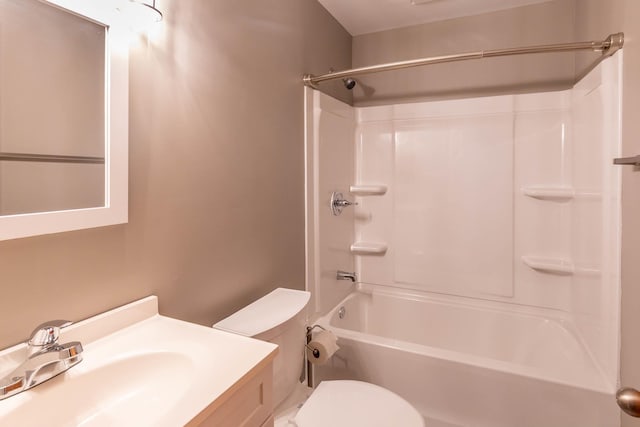 bathroom featuring vanity, toilet, and  shower combination