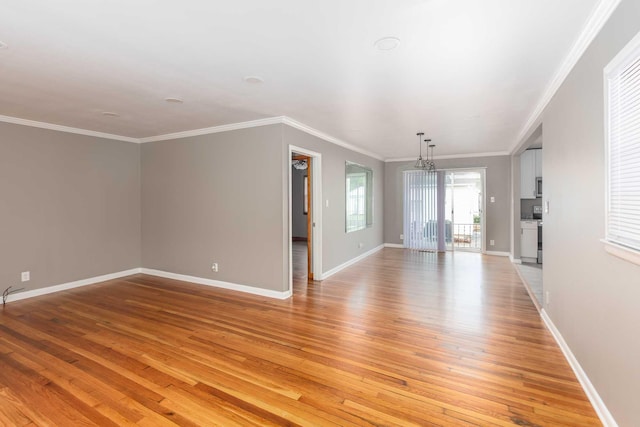 unfurnished living room featuring ornamental molding, baseboards, and light wood-style floors