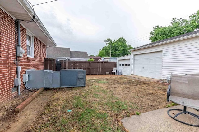 view of yard with fence and a garage