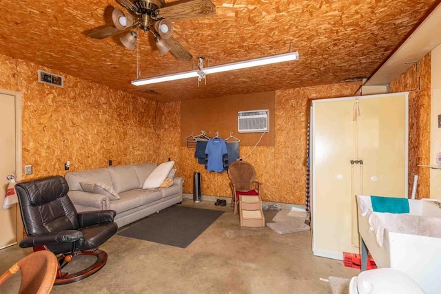 living room featuring visible vents, a ceiling fan, concrete floors, and a wall mounted air conditioner