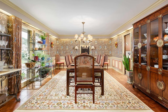 dining space with crown molding, a wealth of natural light, and a notable chandelier