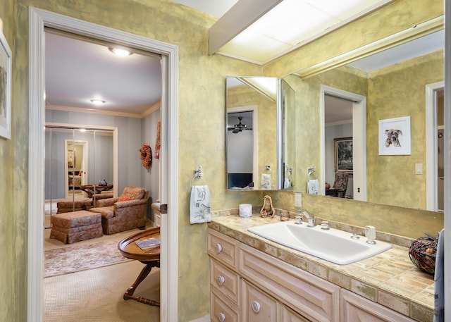 bathroom with vanity, ceiling fan, and crown molding