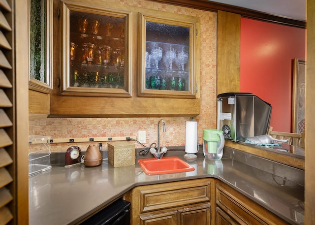 kitchen with crown molding, sink, and black dishwasher