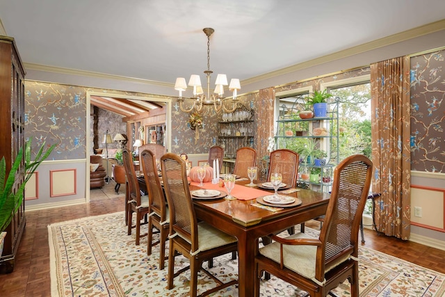 dining room with a notable chandelier, parquet flooring, and ornamental molding