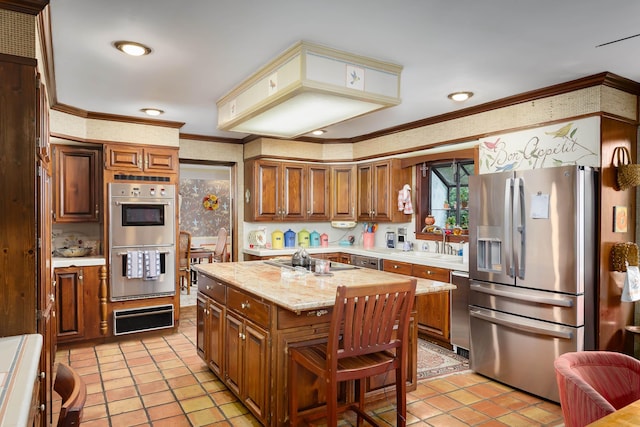 kitchen with appliances with stainless steel finishes, ornamental molding, sink, light tile patterned floors, and a kitchen island