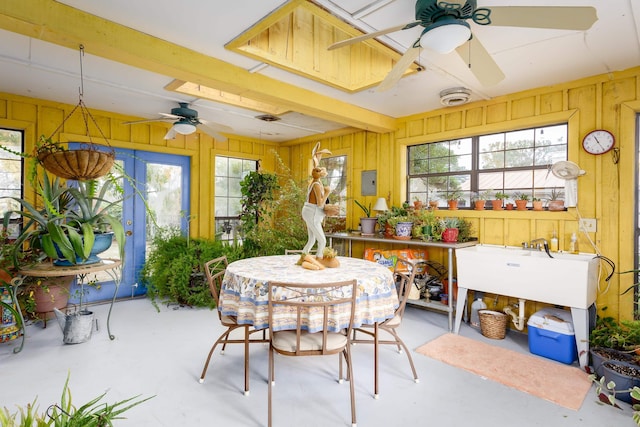 sunroom / solarium with electric panel and ceiling fan