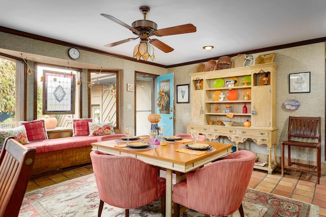 dining space featuring ceiling fan, light tile patterned floors, and crown molding