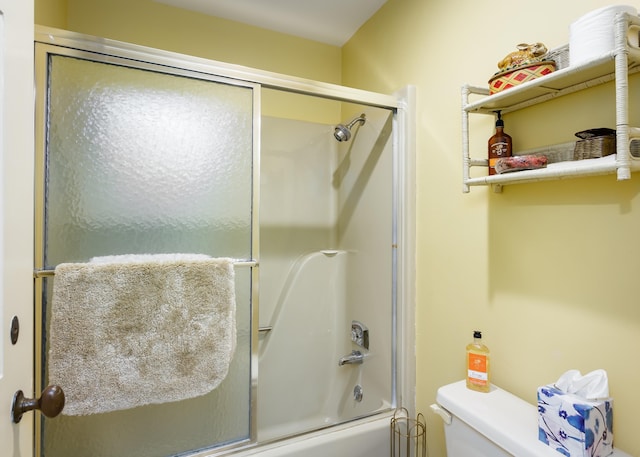 bathroom with toilet and enclosed tub / shower combo