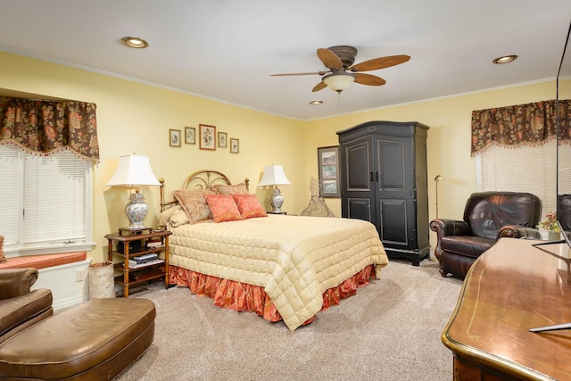 carpeted bedroom featuring multiple windows, ceiling fan, and ornamental molding