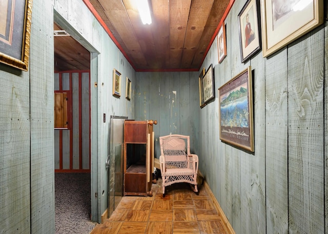 hallway with wood walls, dark parquet floors, and wood ceiling