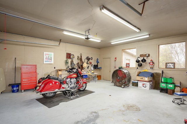 garage with a workshop area and a garage door opener