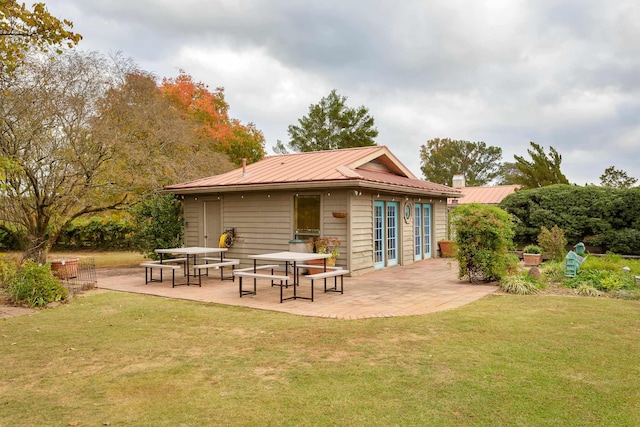 rear view of house with a patio area and a yard