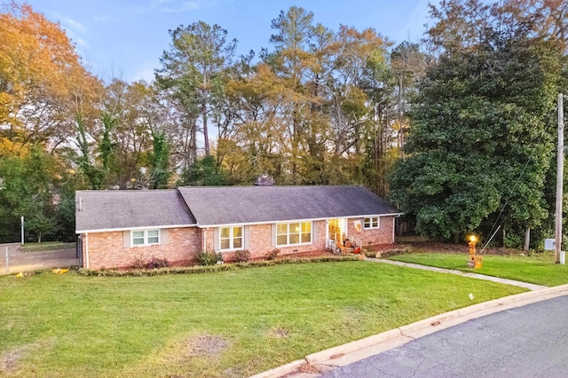 ranch-style house featuring a front lawn