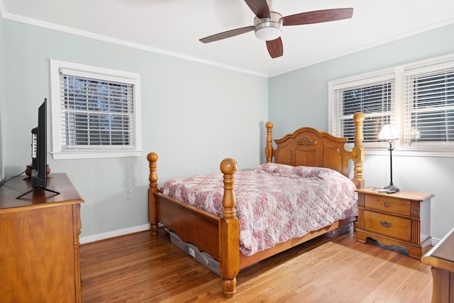 bedroom with ceiling fan, light wood-type flooring, and ornamental molding