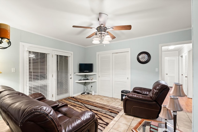 tiled living room with ceiling fan and ornamental molding