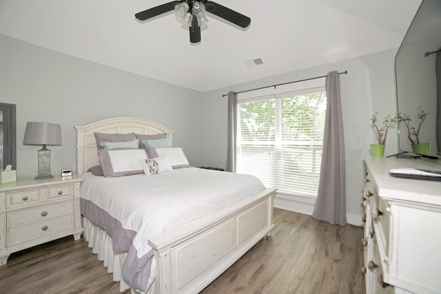  - bedroom with a ceiling fan, wood finished floors, and visible vents