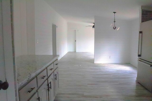  - hallway with light wood-type flooring
