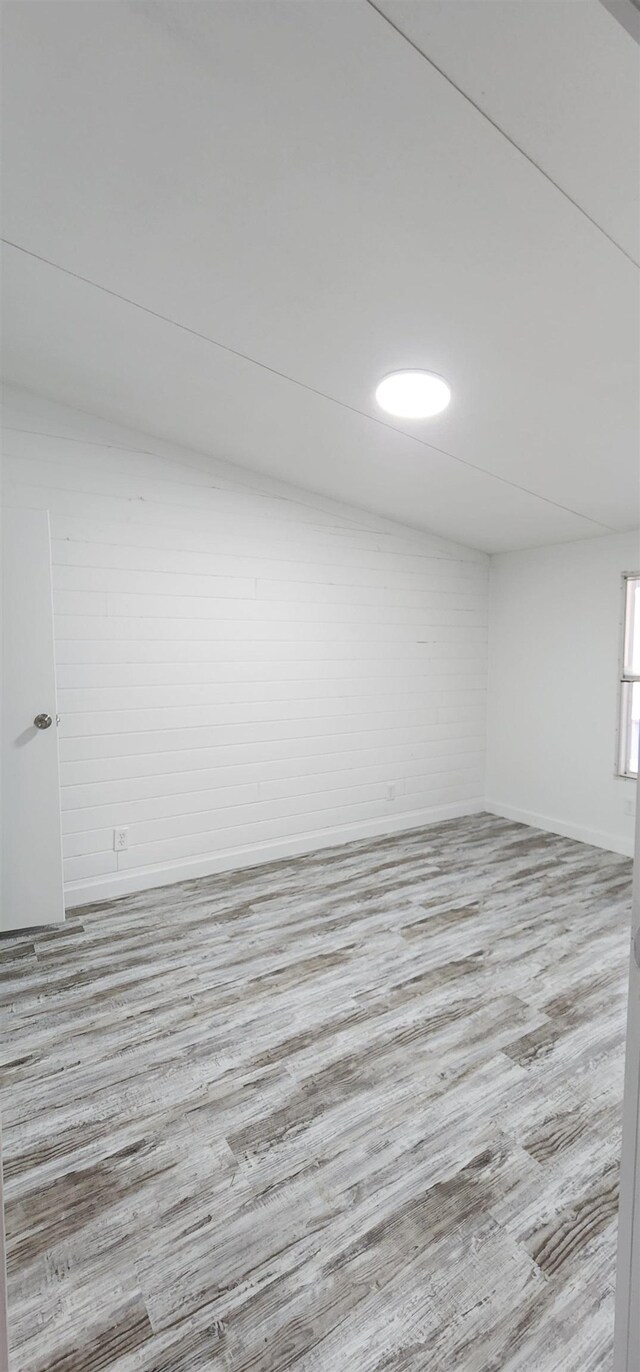  - unfurnished room with wood finished floors and baseboards