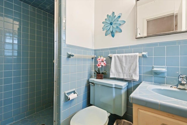 bathroom featuring vanity, an enclosed shower, tile walls, and toilet