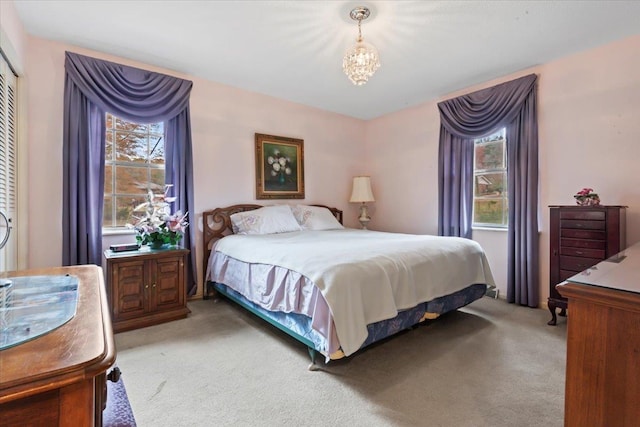 carpeted bedroom with a chandelier