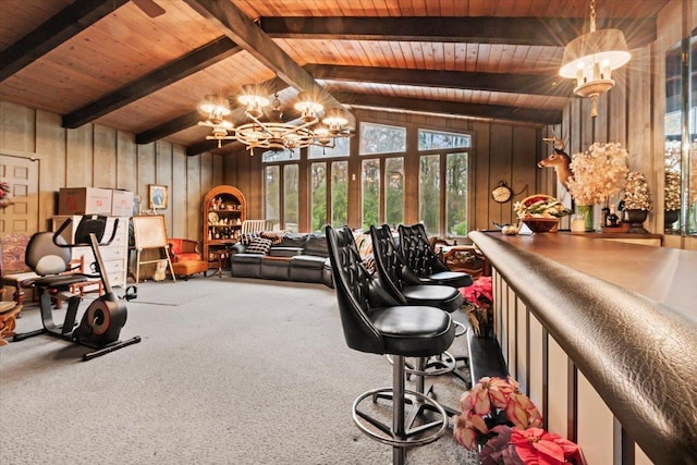 carpeted office featuring a chandelier, lofted ceiling with beams, wood ceiling, and wood walls