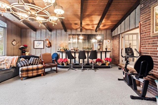 interior space with carpet floors, wood walls, and wood ceiling