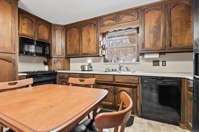 kitchen featuring black appliances and sink