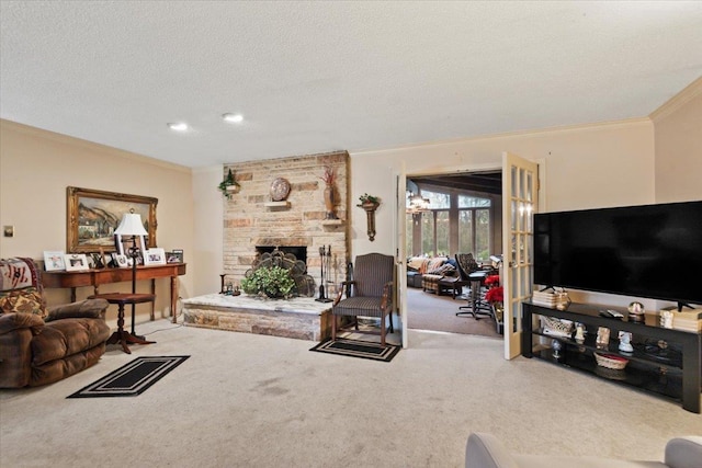 carpeted living room with a textured ceiling, a stone fireplace, and ornamental molding