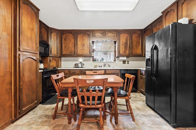 kitchen featuring black appliances and sink