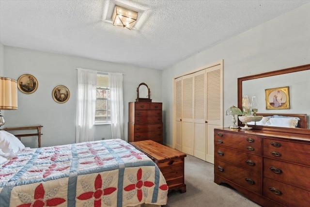 carpeted bedroom featuring a closet and a textured ceiling