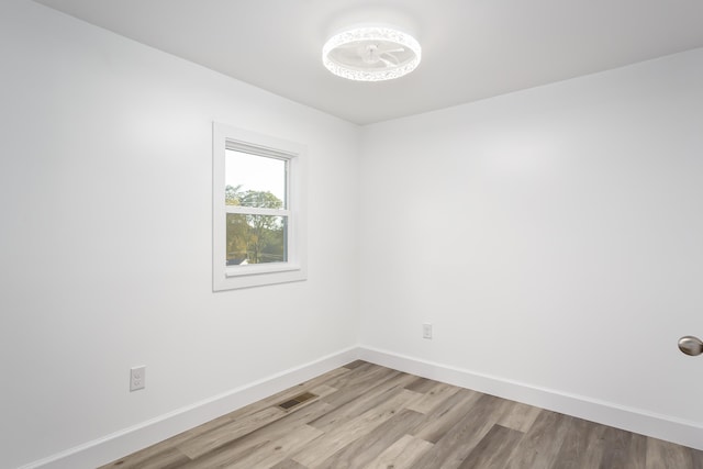  - unfurnished room featuring wood finished floors and baseboards