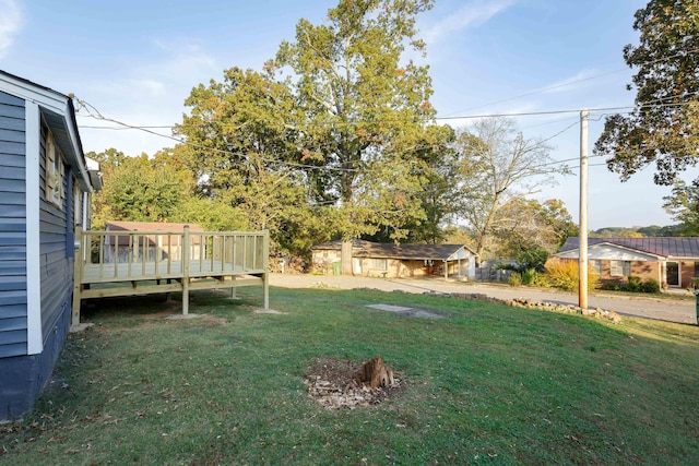  - view of green lawn featuring a wooden deck
