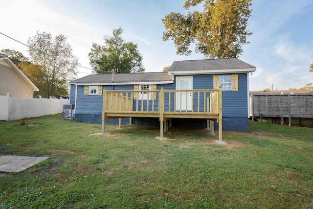  - back of property featuring a deck and central AC