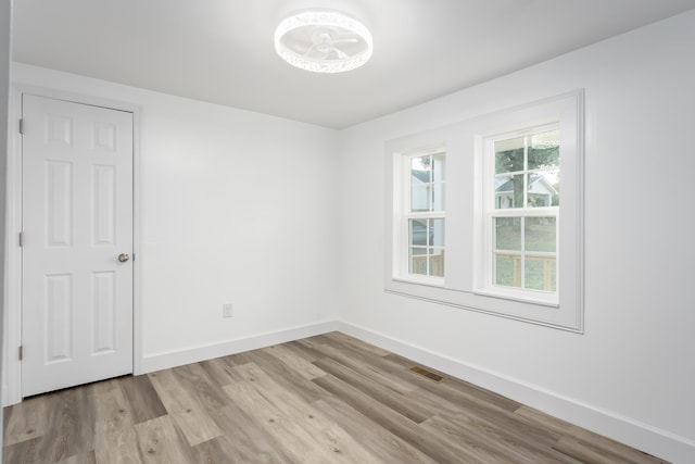  - unfurnished room featuring wood finished floors and baseboards
