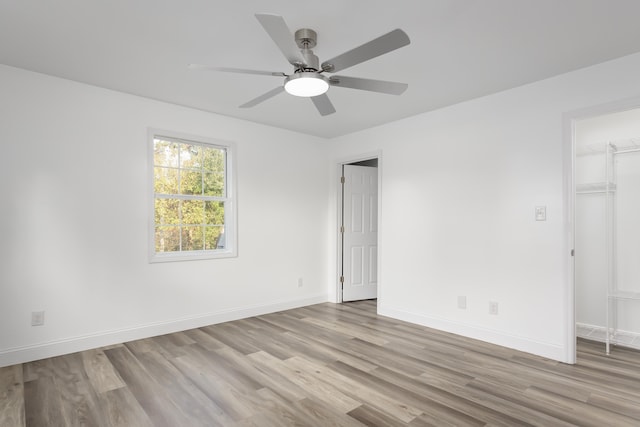  - empty room featuring light wood-type flooring, ceiling fan, and baseboards