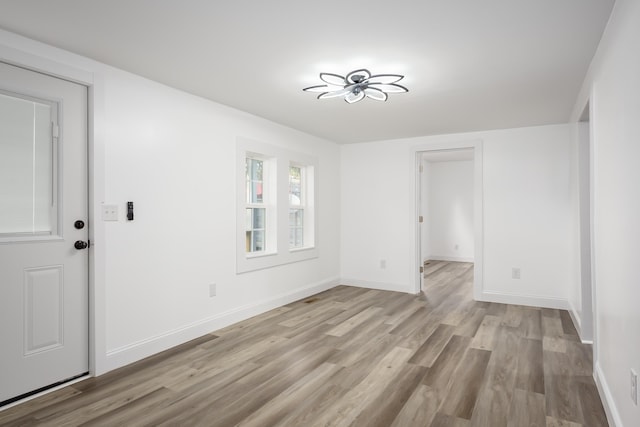  - unfurnished room featuring light wood-type flooring and baseboards