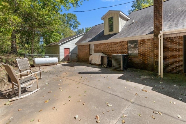 back of house featuring a patio area and central air condition unit