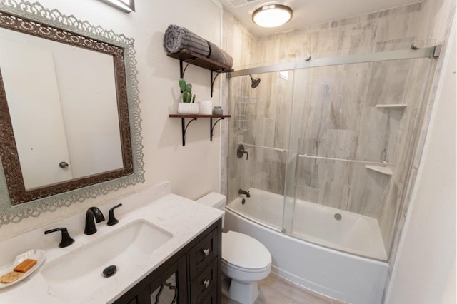 full bathroom featuring hardwood / wood-style flooring, toilet, vanity, and combined bath / shower with glass door