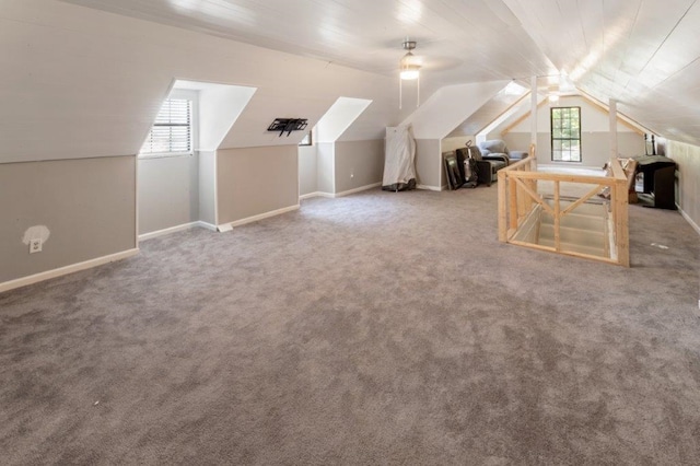 additional living space featuring ceiling fan, plenty of natural light, and vaulted ceiling