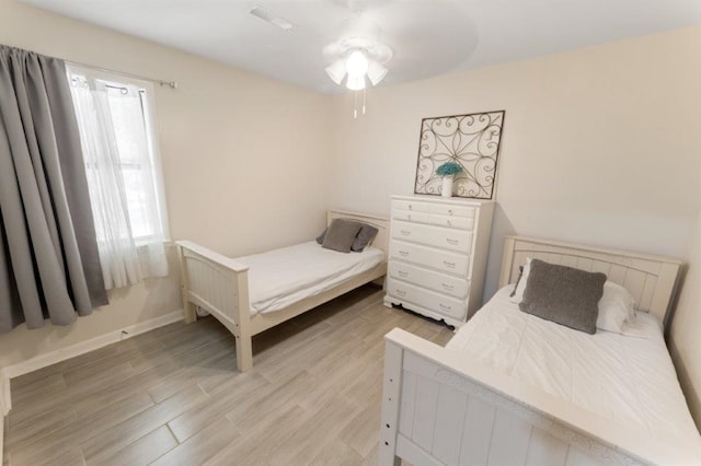 bedroom featuring light hardwood / wood-style flooring and ceiling fan