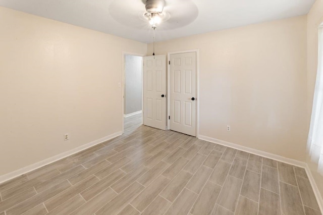 unfurnished room with ceiling fan and light wood-type flooring