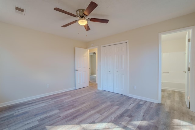 unfurnished bedroom featuring light hardwood / wood-style floors, a closet, and ceiling fan