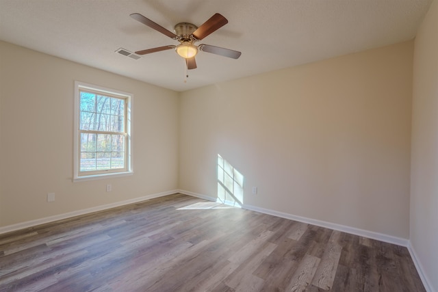 unfurnished room with hardwood / wood-style floors and ceiling fan