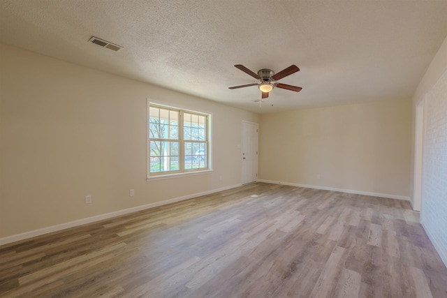 unfurnished room with ceiling fan, light hardwood / wood-style flooring, and a textured ceiling