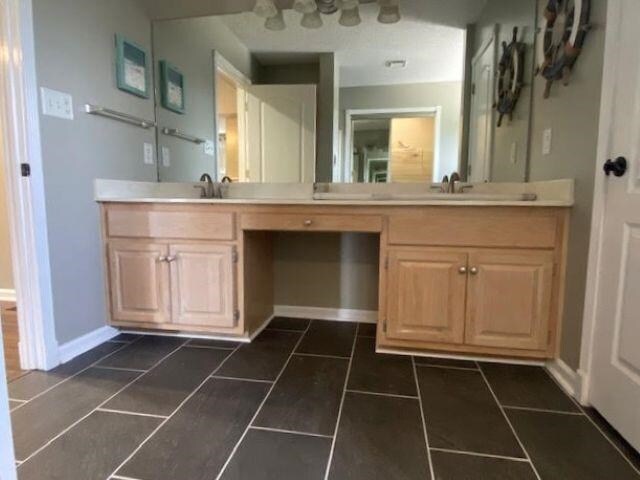  - bathroom with vanity and baseboards