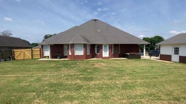  - back of house featuring a hot tub and a gate
