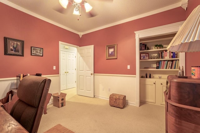 office featuring light carpet, ceiling fan, and crown molding