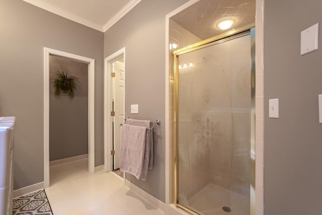 bathroom featuring a shower with door and ornamental molding