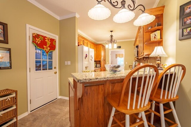 kitchen featuring pendant lighting, white refrigerator with ice dispenser, crown molding, kitchen peninsula, and a chandelier